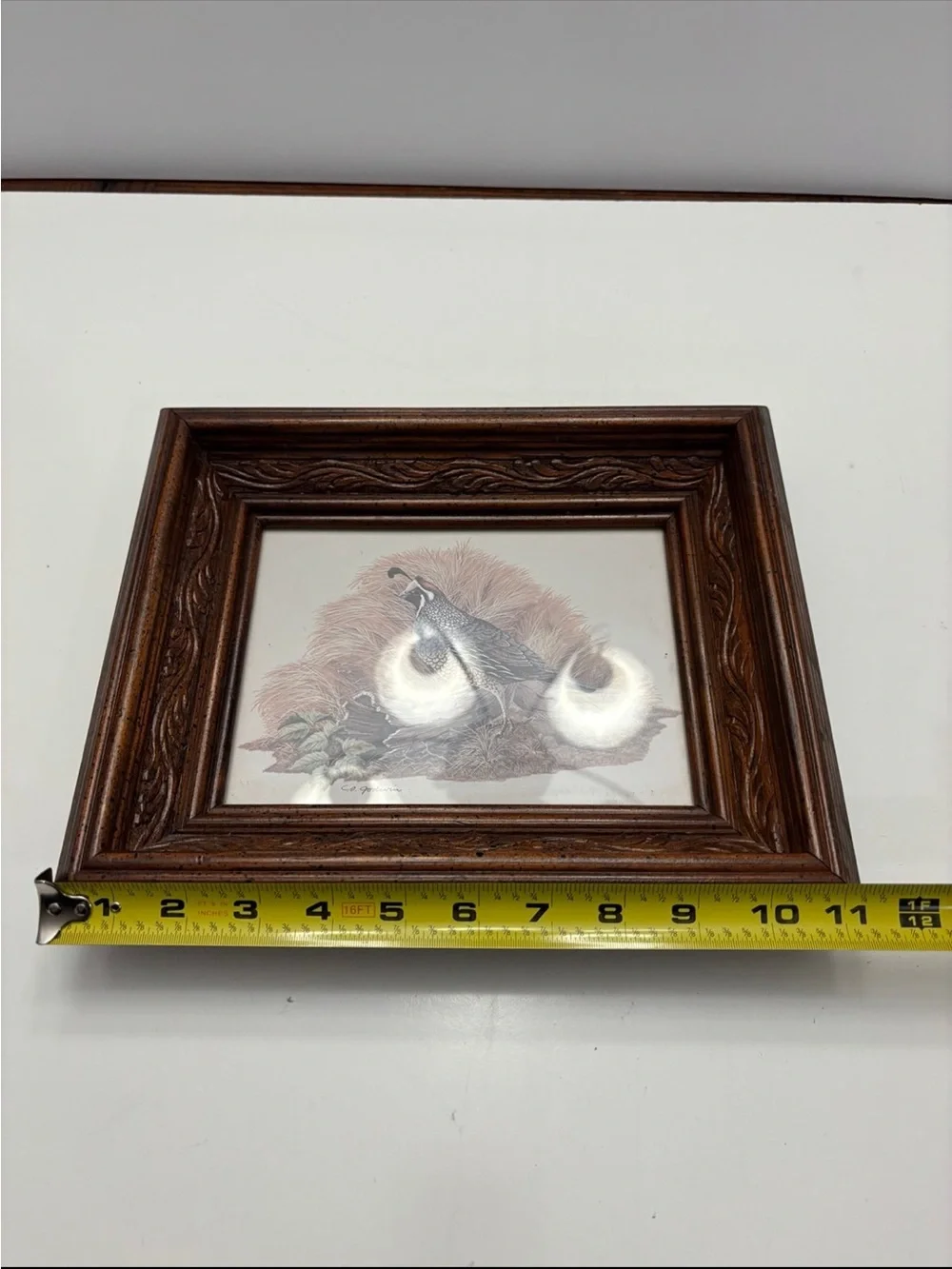 Vintage quail wall art with a rustic, carved wood frame